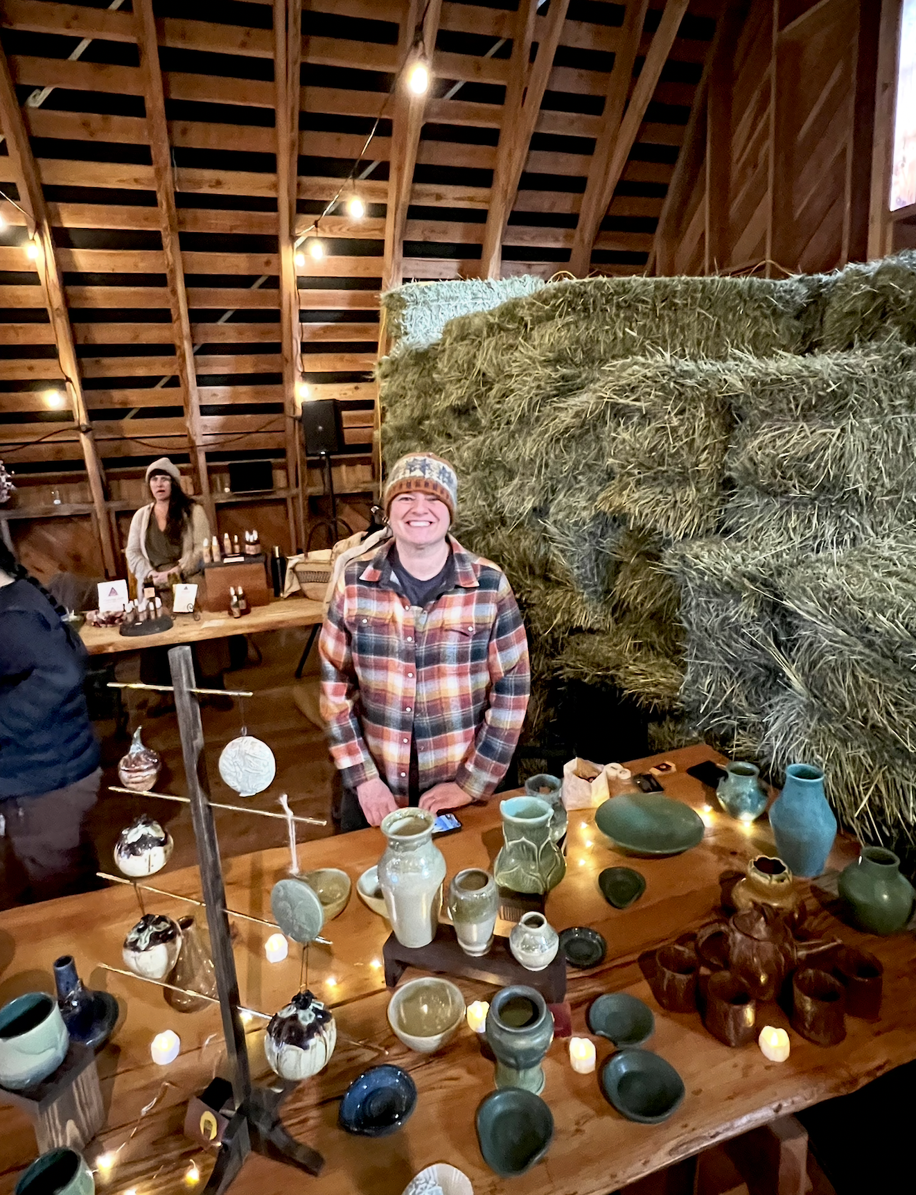 Amanda standing behind her pottery at a market